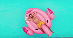 Man, rest and floating in swimming pool outdoor for summer vacation, luxury resort and hospitality trip. Aerial, male person and relax for inflatable flamingo, water and holiday destination at lodge 
