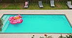 Drone, couple and rest in swimming pool outdoor of summer vacation, luxury resort and honeymoon trip. Aerial, people and relax with inflatable flamingo, water and holiday destination of relationship
