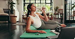 Yoga, laptop and woman drinking water in home for body health, wellness and exercise tutorial. Bottle, hydration and person on floor for workout, start pilates and online fitness course on computer