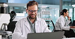 Thinking, scientist or man on laptop in lab for science breakthrough, clinical trial or discovery. Online, medical study or brainstorming ideas on technology for vaccine research, cure or development