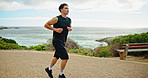 Fitness, running and health with man in nature for marathon practice, exercise and performance. Workout, wellness and cardio with person training at park for sports athlete, challenge and race