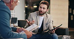 Conversation, documents and tablet with business people in lobby of office for discussion or planning. Chair, collaboration and meeting with employee people in workplace for report or research