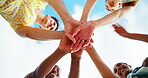 Hands stack, friends and people with unity, below and happy for collaboration, students and together. Sky, community and group with smile for college, team and solidarity for education or partnership