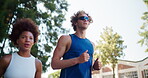 Workout, exercise and interracial couple in town for cardio, fitness and marathon training. Low angle, running and young man with woman for endurance, love and health with runner on road with energy