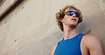 Athlete, fitness and man with resting outdoor for exercise break, breathing or running recovery. Runner, person or tired with sunglasses for cardio challenge, marathon training or workout performance