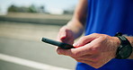 Fitness, hands and man with typing with phone outdoor for tracking workout app, running progress and speed stats. Runner, road or closeup of athlete with smartphone for online search or exercise tips