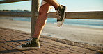 Feet, boardwalk and person by beach on holiday, vacation or getaway on spring break. Legs, shoes and travel by ocean water for tropical weekend trip by seaside for relax, calm or peace outdoor.