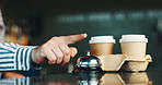 Coffee shop, hands and person with bell, business and takeaway order with friendly service. Closeup, barista and customer with hospitality, espresso and worker with collection point and process