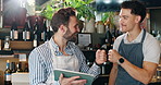 Tablet, men and waiters with fist bump in coffee shop for startup business with online menu. Happy, digital technology and male baristas with celebration for positive customer review for cafe.