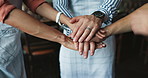 Group, stack hands and people at cafe with waiter, goals and celebration for success at small business. Team, solidarity and support with cheers, motivation and achievement with sales at cafeteria
