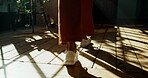 Walking, home and person with shoes, fashion or cool sneakers on wooden floor for back view. Ground, legs and feet with steps to travel on oak planks in house living room with footwear for journey