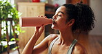 Home, woman and fitness with drinking water for wellness, hydration or nutrition for healthy body. House, female person and break with thirst for h2o liquid, detox or self care after exercise session