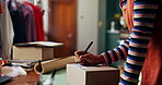 Woman, box and writing for small business, clothes and creative fashion boutique startup with online sales. Designer, owner and distribution for store packaging, retail service and ecommerce delivery