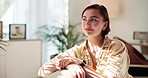 Thinking, smile and woman on sofa in home with self reflection, mental health and peace. Remember, relax and female person in living room with wellness decision, choice or memory in apartment.