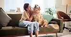 Home, woman and playing with dog on sofa for comfort, bonding or domestic companion. Loyalty, happy owner or golden retriever in living room with stroke, scratch and love for trust, relax or security
