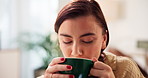 Sofa, woman and relax with coffee to drink, comfortable and happiness with espresso at home. House, female person and chilling in morning for warm cappuccino, caffeine and thinking in living room