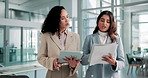 Women, tablet and documents for discussion at office, planning or review stats with advice at insurance company. People, partner and results for risk management report with app for feedback at agency