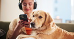 Home, dog and woman with phone for headphones, podcast and bonding with domestic pet on sofa. House, animal and golden retriever with female person for mobile sound, audio track or listening to music