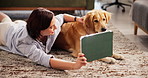 Smile, tablet and woman with dog on floor of living room for bonding, reading or streaming. Love, relax or wellness with animal and happy pet owner in home together for companionship or loyalty