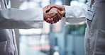 Handshake, deal and team of scientists in laboratory for biotechnology partnership. Agreement, collaboration and biologists with shaking hands for pharmaceutical innovation with medical contract.