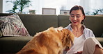 Relax, care and woman with dog in living room in home for bonding, connection or companion. Happy, adoption and female person on floor with golden retriever pet for rubbing animal, pet or puppy.