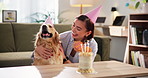 Birthday, cake or candles with dog and woman in living room of apartment together for celebration. Cuddles, love and smile of pet owner with labrador in apartment for bonding, milestone or party