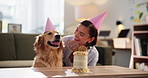Cake, cuddle or party with dog and woman in living room of apartment together for celebration. Birthday, love and smile of pet owner with labrador in apartment for bonding, friendship or milestone