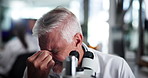Mature scientist, man and microscope with headache at laboratory, tired and stress with sample in medical research. Person, migraine and pain with clinical study, burnout and fatigue with pharma job