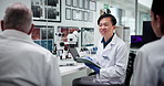 Science, tablet and talking with people in laboratory together for collaboration or discussion. Healthcare, medical and report with team at work on clinical trial for feedback, innovation or research