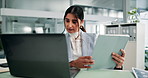 Laptop, tablet and review with business woman at desk in office for administration or research.  Computer, information and reading with Indian employee in workplace for online feedback or report
