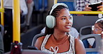 Bus, headphones and woman with phone in city for journey, commute and travel on social media in town. Public transport, passenger and person on vehicle listening to podcast, audio and music on trip