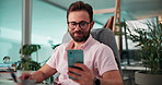 Business, man and happy with smartphone in office for email notification, checking text message or smile. Corporate finance manager, computer or reading with phone at desk for online research or chat