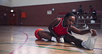 Fitness, legs and stretching with black woman on basketball court for training preparation. Exercise, sports and warm up with African athlete in gymnasium for start of competition, game or match