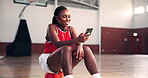 Student, basketball or woman with phone in college on social media for break or entertainment. Court, smile and African girl athlete with mobile for workout, sports scholarship or fitness training