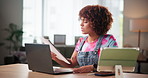 Woman, laptop and reading document at house for planning, ideas and solution as graphic designer. Person, tablet and typing for website research, problem solving and proposal feedback for remote work