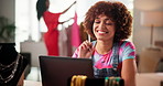 Woman, fashion and happy with laptop in workshop with sales report, order or profit with online shopping website. Person, pc and excited for logistics, revenue and clothes for dropshipping in studio