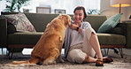Relax, happy and woman with dog in living room in home for bonding, connection or companion. Love, adoption and female person on floor with golden retriever pet for rubbing animal, pet or puppy.