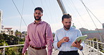 Tablet, walking and business men on bridge in city with company budget planning in collaboration. Teamwork, digital technology and male financial managers with dividend account in urban town.