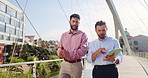 Tablet, walking and business men in city on bridge with company budget planning in collaboration. Teamwork, digital technology and male financial managers with dividend account in urban town.