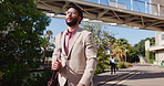 Walking, travel and business man in city for commute, professional and property manager. Real estate developer, morning and downtown with person outdoor for opportunity, moving and confidence