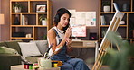 Woman, painter and palette with headphones in home studio with creative process, color or inspiration for project. Person, artist and music with stroke, talent and design in living room at apartment