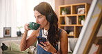 Drink, artist and woman with phone for music or listening to inspiration podcast. Coffee, headphones and painter on mobile for creative hobby, audio and video for art design on canvas in home studio