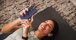 Break, fitness and woman with smartphone, earphones and listening to music for exercise in morning. Streaming, calm and mature person with mobile for audio, workout and smile for song on web in house