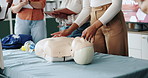 People, hands and first aid training with mannequin for emergency response, assistance or medical class. Group, instructor or healthcare paramedic with demonstration for rescue lesson or assessment