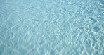 Background, ripples and space with clear water outdoor at hotel or resort for relax or wellness. Holiday, summer and vacation with swimming pool at lodge for accommodation or hospitality from above