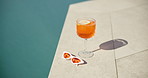 Swimming pool, glass and cocktail with sunglasses for summer vacation, holiday and relax outdoor. Water, alcohol and drink at hotel resort for tourism, travel and luxury with fresh lemon beverage