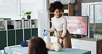 First aid, mannequin and woman with presentation, teaching and workshop for skills development. Group, medical and presenter with advice, healthcare and course for emergency, doll for cpr or learning
