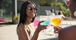 Happy women, friends and drinking with cheers at pool for summer holiday, vacation or weekend at party. Female people, toast or cocktail with sunglasses for good vibes or fun time at luxury resort