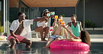 Happy people, friends and cheers with drinks at pool party for summer holiday, vacation or weekend. Group, gathering or celebration with toast or glasses in relax for good vibes or fun time at resort