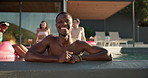 Face, party and happy man with smile in swimming pool together for holiday or vacation. Relax, summer and person in water with group of friends or people at hotel, lodge or resort for weekend getaway
